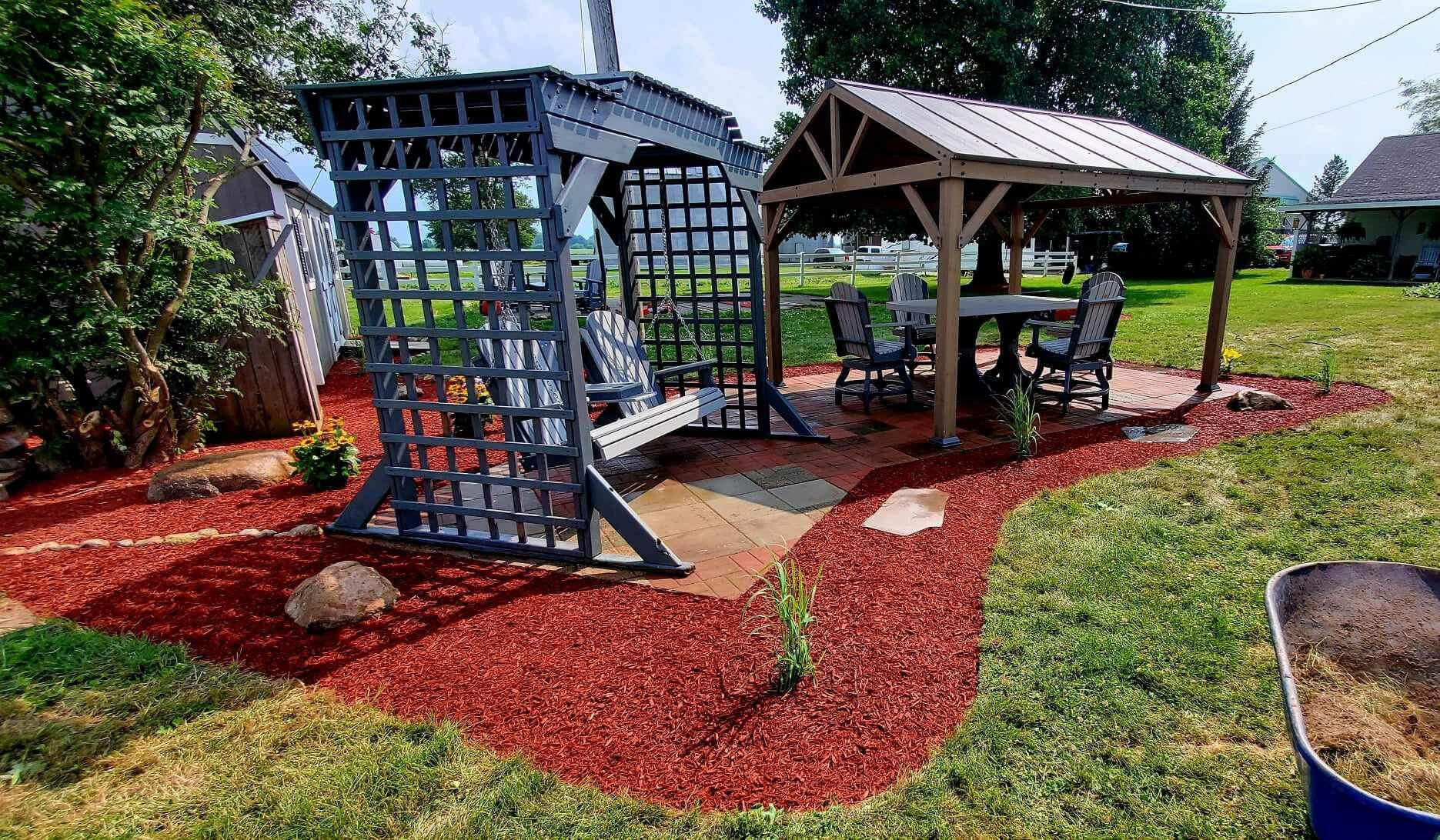 Contemporary pergola patio setup in Indianapolis, surrounded by stylish and functional mulch beds.